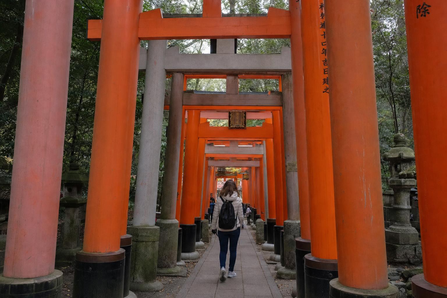 AI-generated illustration: A traveler walking beneath the red torii gates at Fushimi Inari Taisha, Kyoto, Japan