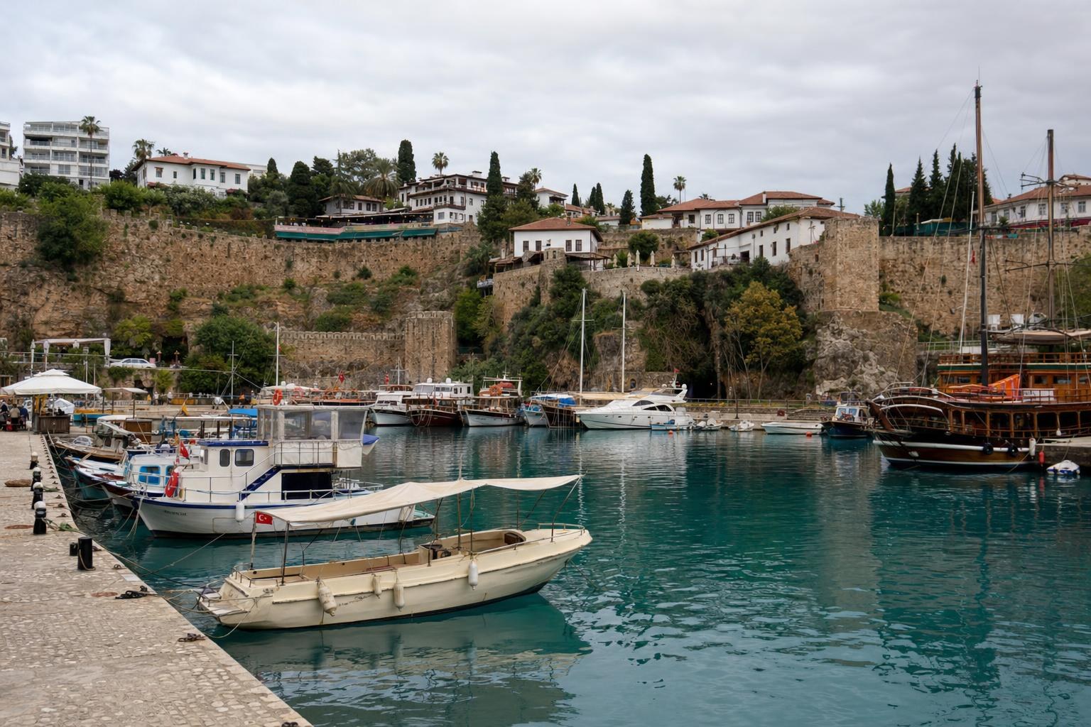 AI-generated illustration: A view of Kaleiçi harbour front in Antalya with moored boats and old city walls