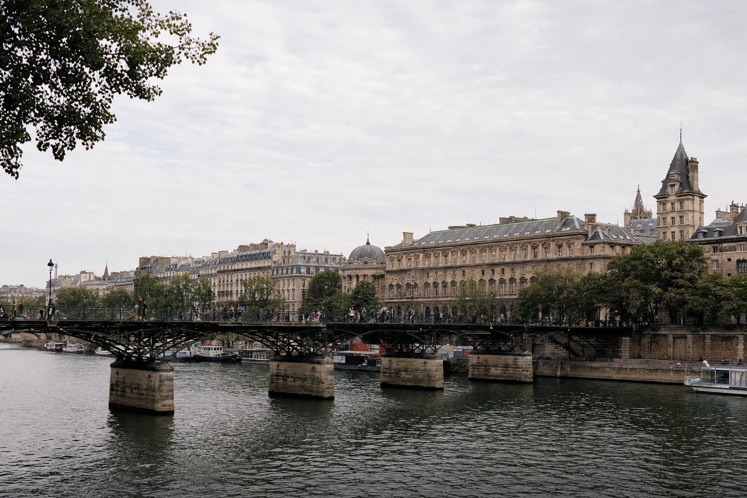 AI-generated illustration: A riverside scene showing a pedestrian bridge and historic Parisian buildings on Île-de-la-Cité, Paris, France